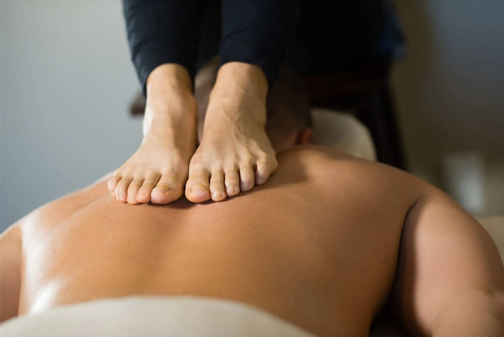 Woman giving massage with feet