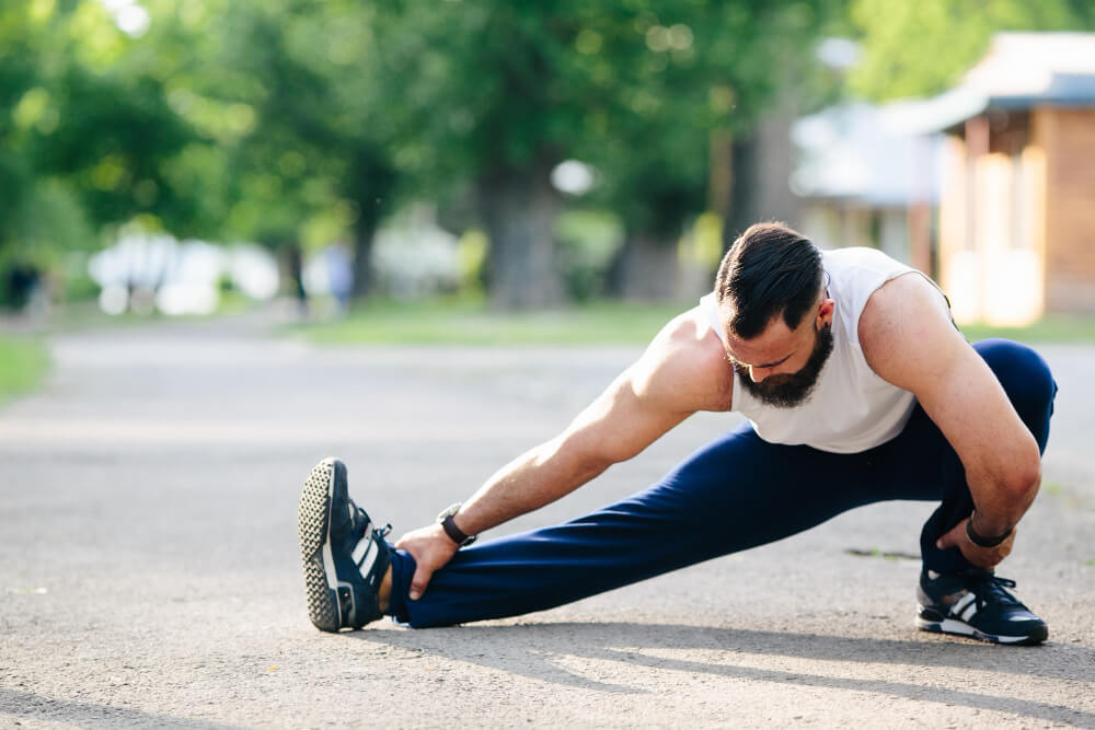Man stretching for injury prevention